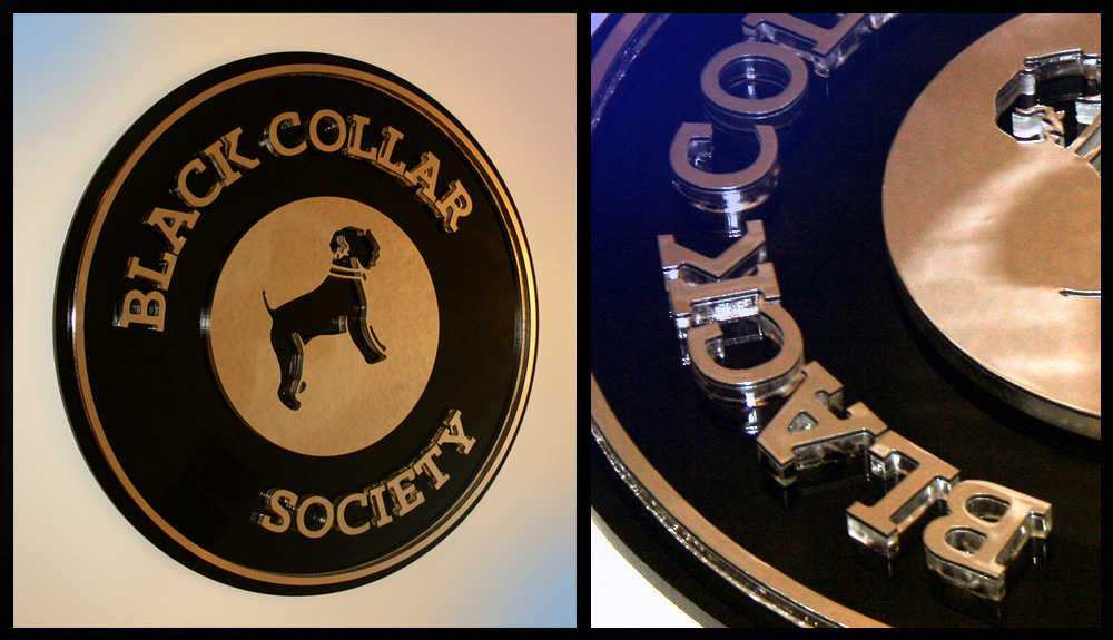 Mirror panel over clear Plexi (letters, inside circle with dog logo cut out, circle border. All bonded to a black Plexi die-cut base. Mirror panel over clear Plexi (letters, inside circle with dog logo cut out, circle border. All bonded to a black Plexi die-cut base.